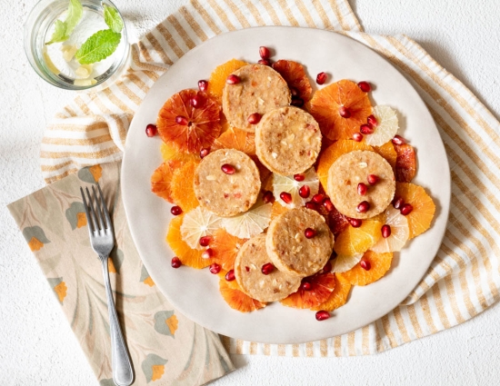 Mini cakes on citrus fruit carpaccio and pomegranate